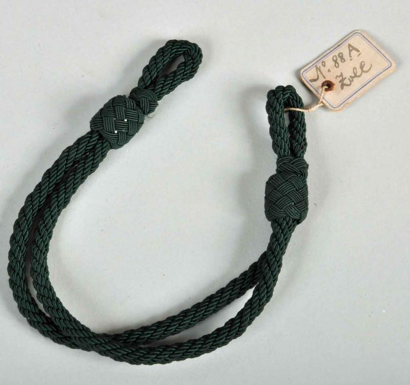 GERMAN WWII  CUSTOMS OFFICIAL’S VISOR CAP CORD WITH PAPER TAG.