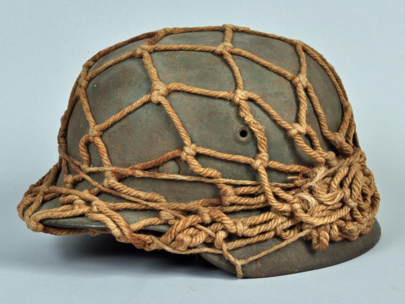 GERMAN WWII M40 HELMET WITH STRING COVER.
