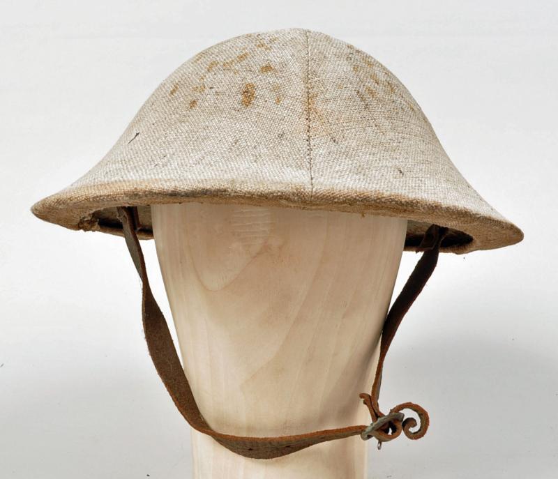 BRITISH WWI RIMLESS BRODIE HELMET WITH COVER.