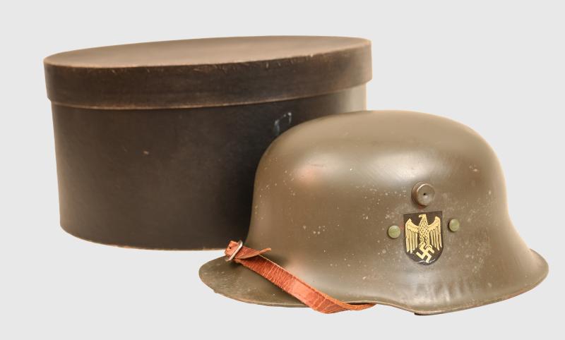 GERMAN WWII CHILD’S STEEL HELMET IN ORIGINAL DELIVERY BOX.