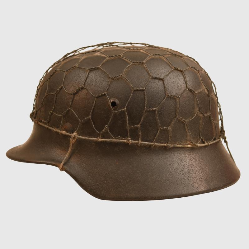 GERMAN WWII ARMY OR SS M35 COMBAT HELMET WITH WIRE COVER.