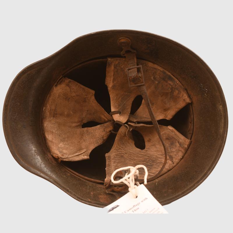 GERMAN WWI M.17 CAMOUFLAGE HELMET, COMPLETE WITH LINER AND THE RARE CHINSTRAP.