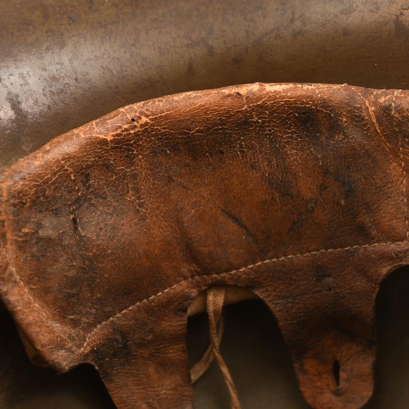 GERMAN WWI M.16 CAMOUFLAGE TRENCH HELMET WITH PARTIAL CHINSTRAP.