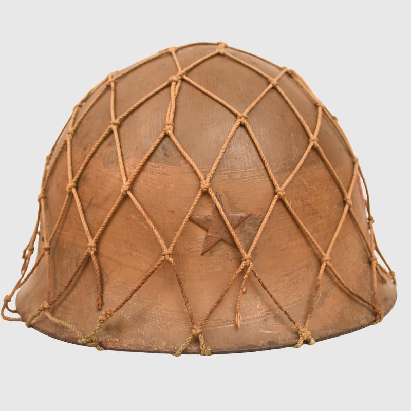 JAPANESE WWII TYPE 90 COMBAT HELMET WITH CAMOUFLAGE NET, IDENTIFIED TO AN INDIVIDUAL SOLDIER.